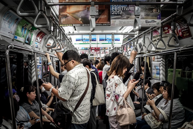 People checking their phone while they are in the train